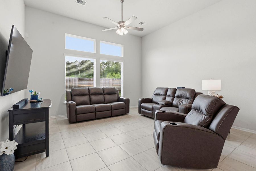 Soaring ceilings and oversized windows fill this living space with natural light and an inviting atmosphere. Soaring ceilings and oversized windows fill this living space with natural light and an inviting atmosphere.