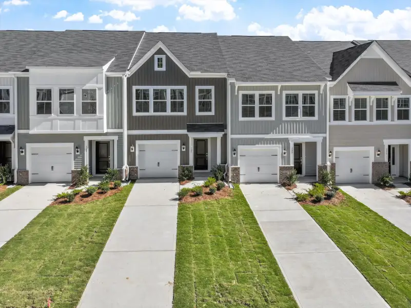 Front exterior of a new home in West Main Townhomes, Sanford, NC, highlighting curb appeal (Image 1). Front exterior of a new home in West Main Townhomes, Sanford, NC, highlighting curb appeal (Image 1).