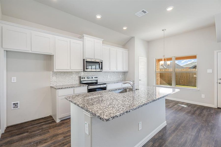 Kitchen featuring appliances with stainless steel finishes, dark hardwood / wood-style flooring, white cabinetry, and sink