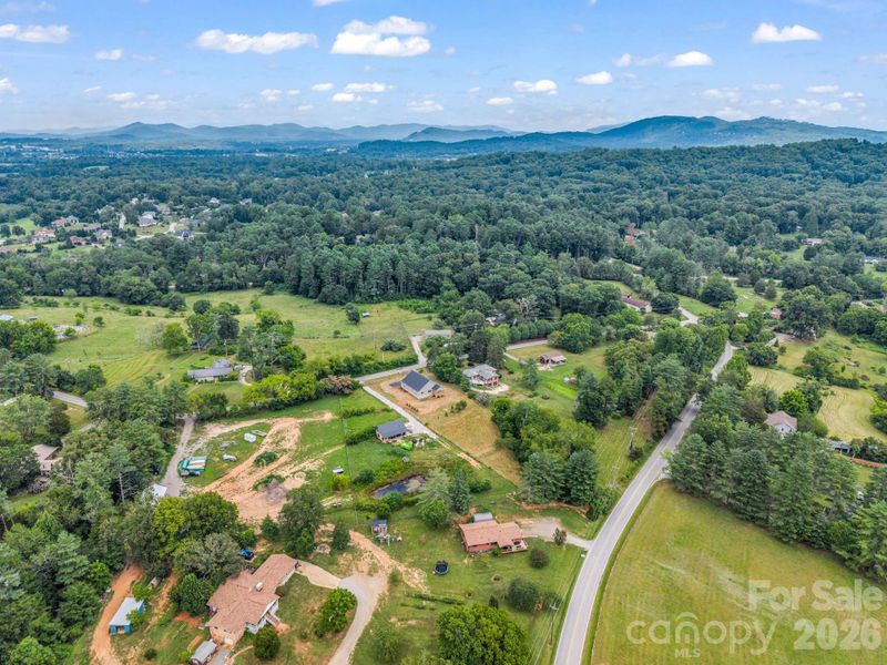 Aerial rear view showing both access roads. Perfect for another driveway for RV, shop or garage. Aerial rear view showing both access roads. Perfect for another driveway for RV, shop or garage.