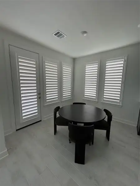 Bright and inviting breakfast nook with Elegant shutters Bright and inviting breakfast nook with Elegant shutters