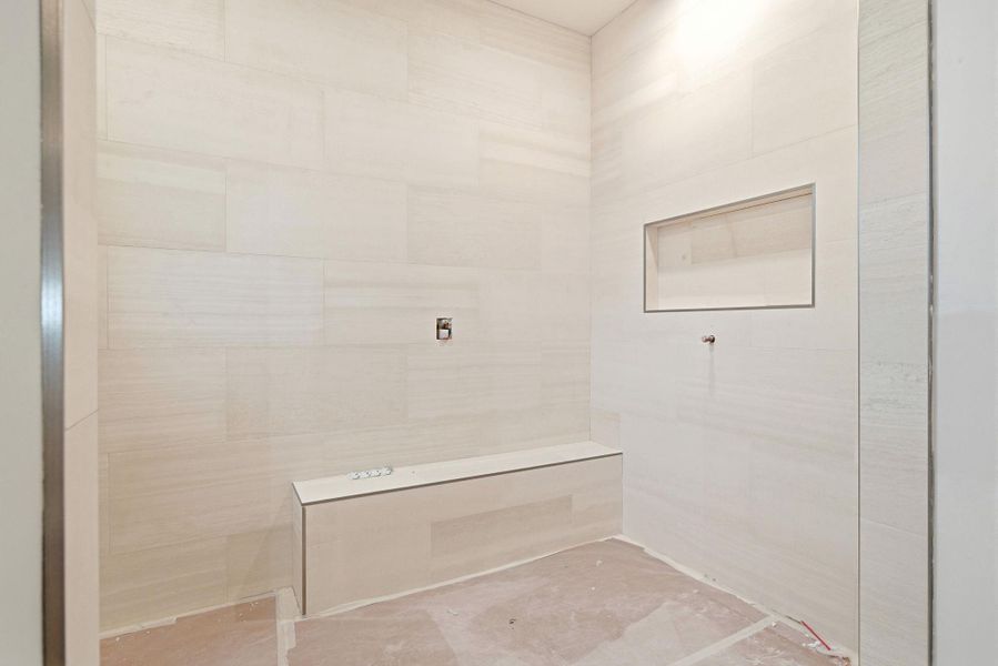 Photo of unfinished primary bath with natural Limestone and travertine tile work.