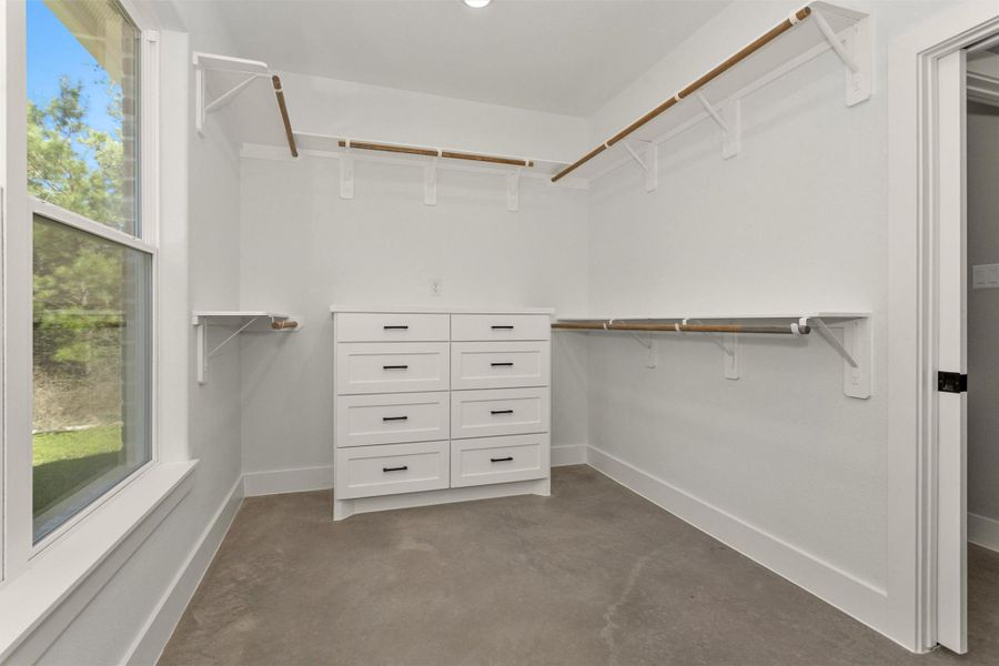 Combining functionality with comfort, this well-appointed closet offers both ample storage and a touch of luxury.