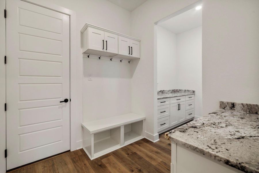 The mudroom features a catch all station. The mudroom features a catch all station.