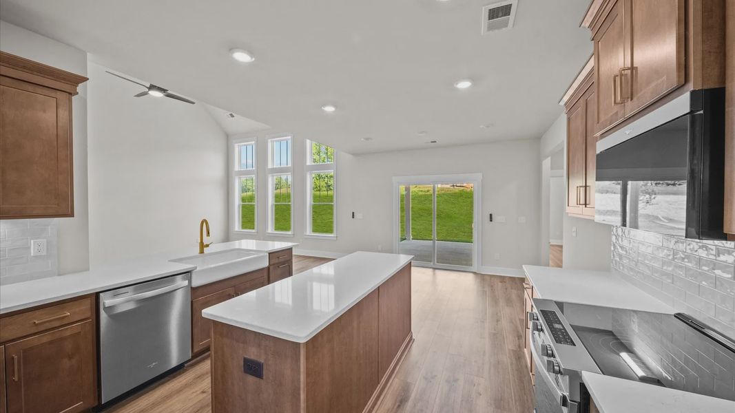 Accomplished design in a kitchen that blends function and form with a right-sized island at Benjamin's Grove