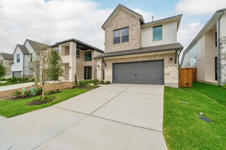 Front exterior of a new home in Parmer Ranch, Georgetown, TX, highlighting curb appeal (Image 22). Front exterior of a new home in Parmer Ranch, Georgetown, TX, highlighting curb appeal (Image 22).