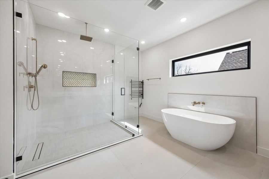 Not to forget the detail of a towel warmer adjacent to the shower door.