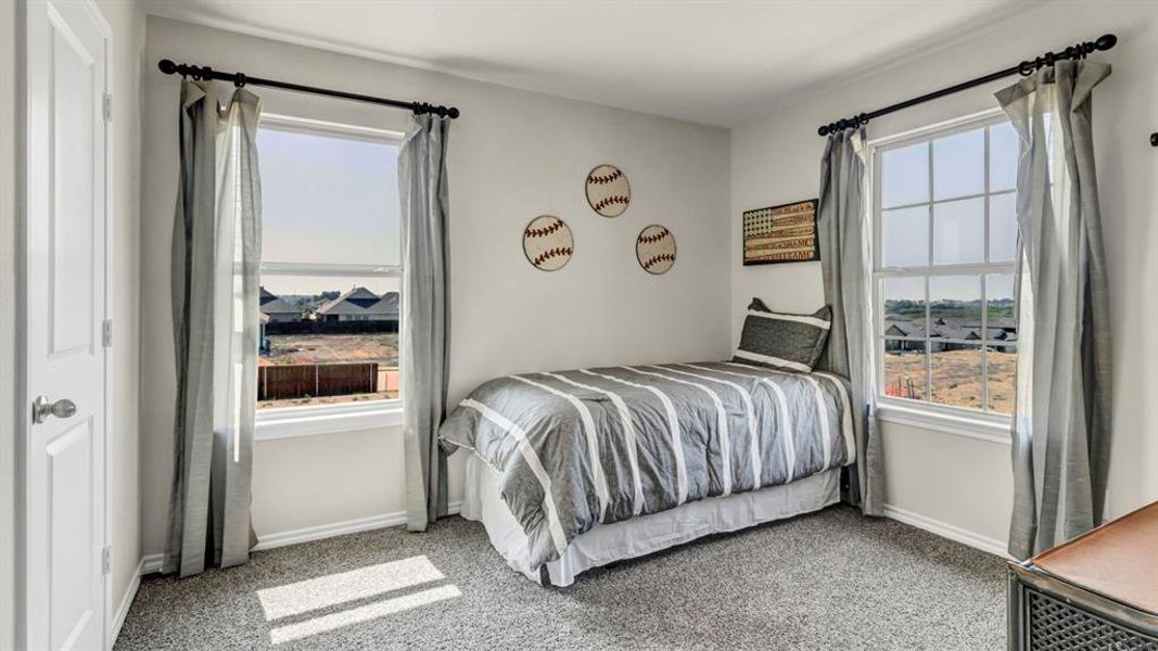 Spacious room featuring two large windows, light gray carpet, and white trim Spacious room featuring two large windows, light gray carpet, and white trim
