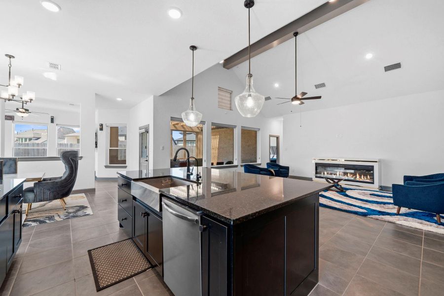 Open-concept kitchen and living space featuring a large island, sleek finishes, and seamless flow—perfect for entertaining.