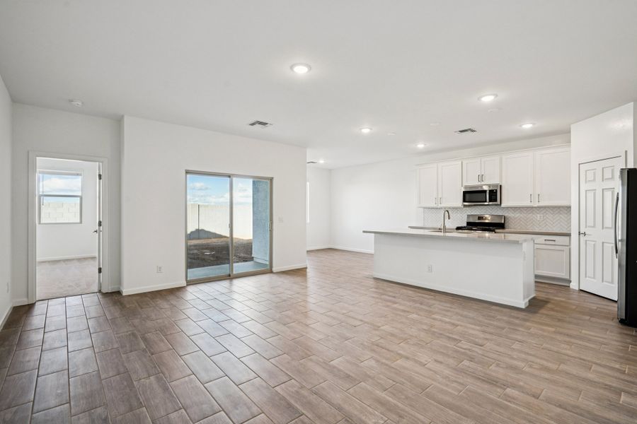 Great room, kitchen and dining. Options and finishes may vary by community.