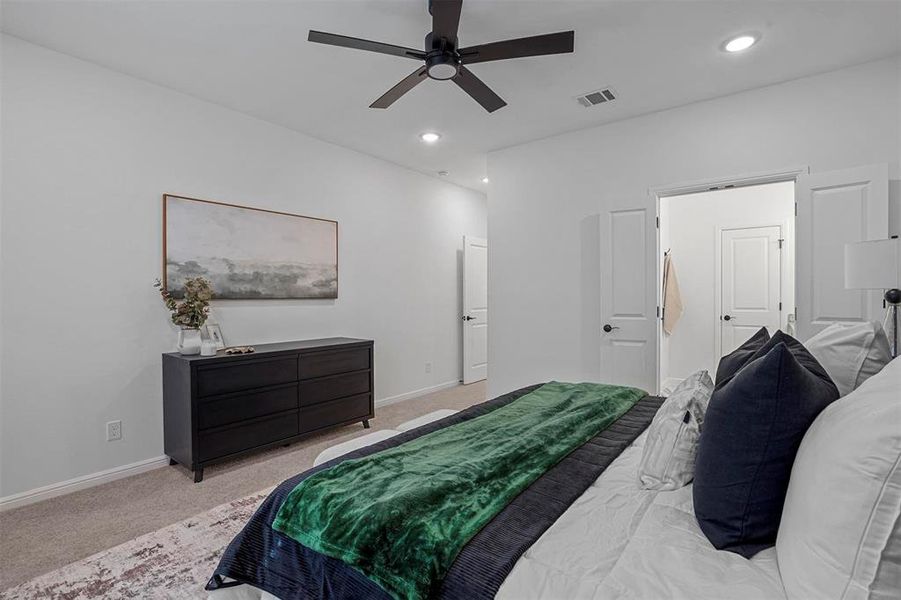 Bedroom with light colored carpet and ceiling fan