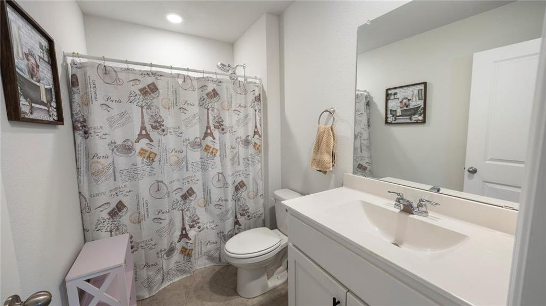 Bathroom featuring vanity and curtained shower