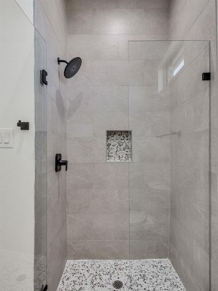 Bathroom featuring tiled shower