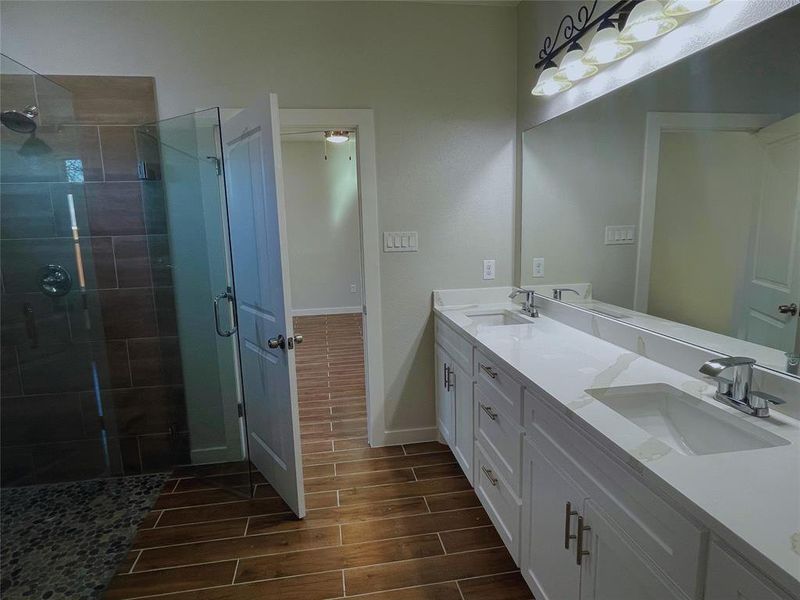 Bathroom featuring vanity and a shower with shower door