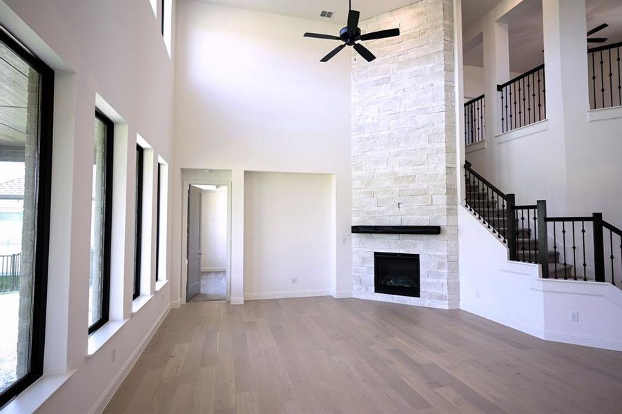 Living Room with floor to ceiling stone gas fireplace and towering ceilings