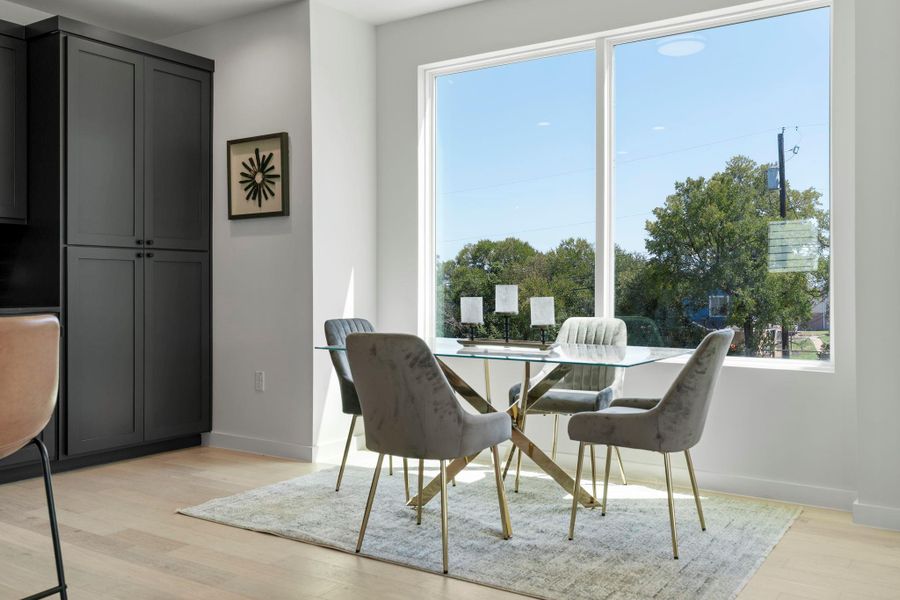 Dining area with light wood finished floors and baseboards