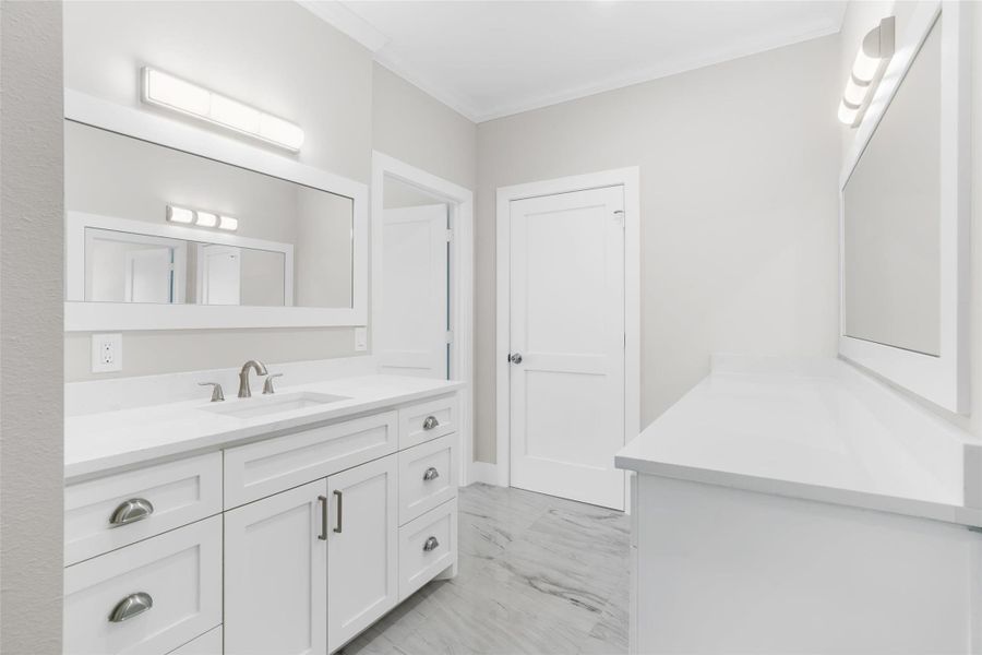 First floor bathroom featuring tile floors, framed mirrors, added counter space and plenty of storage First floor bathroom featuring tile floors, framed mirrors, added counter space and plenty of storage