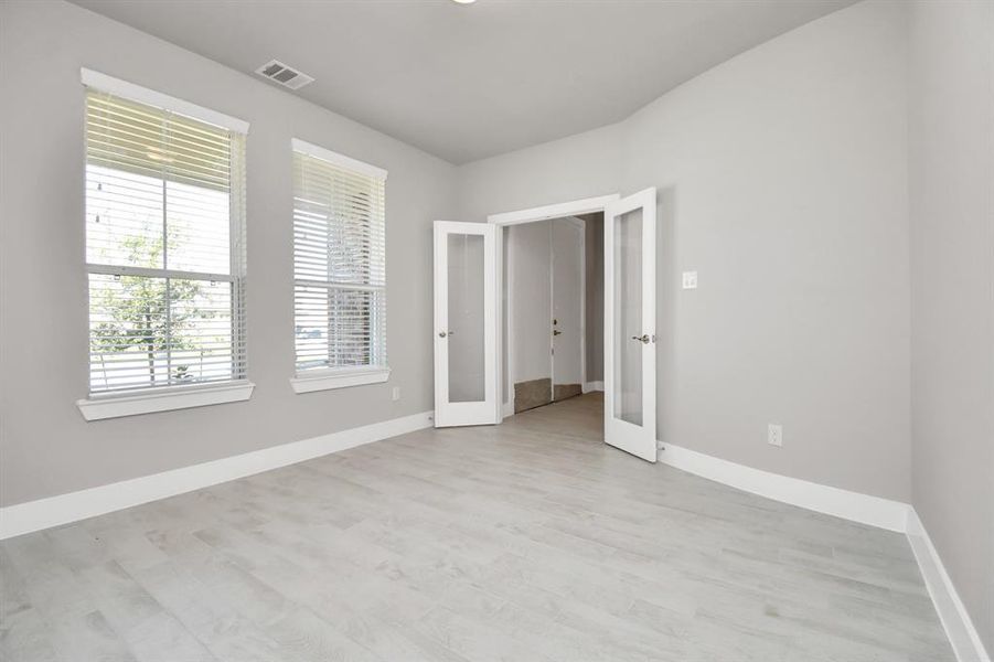 Step into an inviting home office, adorned with premium soft carpet that infuses the workspace with a sense of freshness and comfort. Bask in the inspiring glow of natural lighting pouring through the window, setting the perfect stage for enhanced productivity and unwavering focus. Sample photo of completed home with similar floor plan. Actual colors and selections may vary.