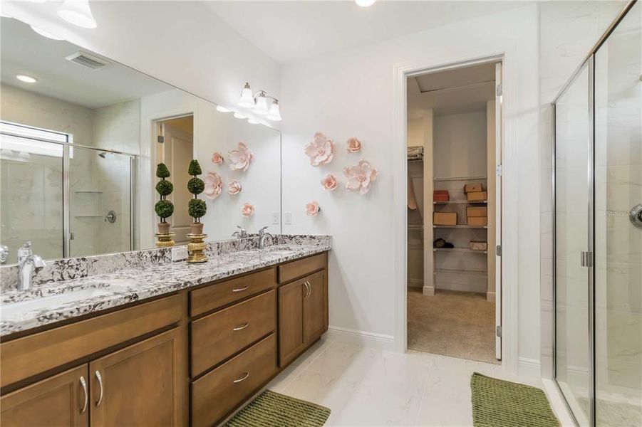 Large Owner's Bath with dual sinks, Standup Ceiling to floor Tile Shower and private water closet.