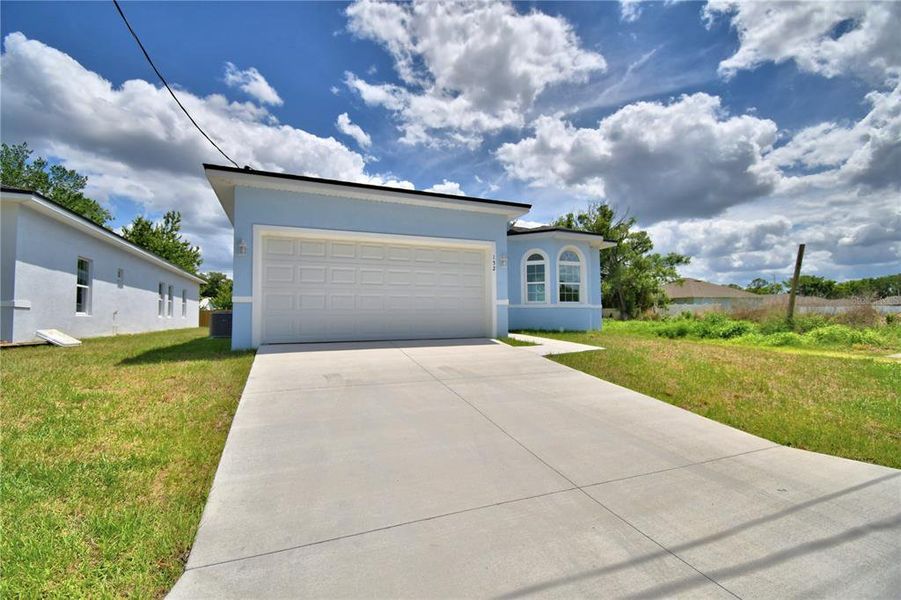 Front exterior of a new home in , Winter Haven, FL, highlighting curb appeal (Image 19).