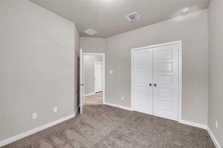 Unfurnished bedroom with carpet floors and a closet
