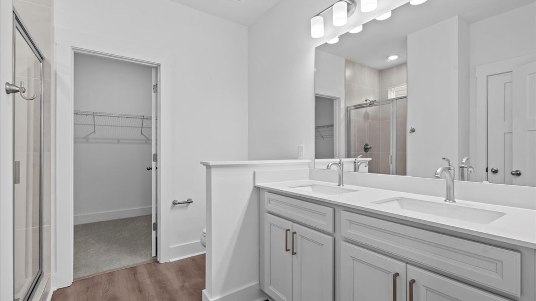 First-rate primary bathroom offering an elegant walk-in shower and dual sinks with superior style located at Pleasant Falls