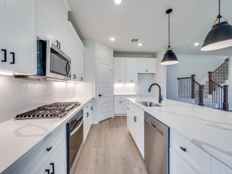Classic white cabinetry and beautiful countertops paired with stainless appliances make this a kitchen any chef would be proud to call their own!