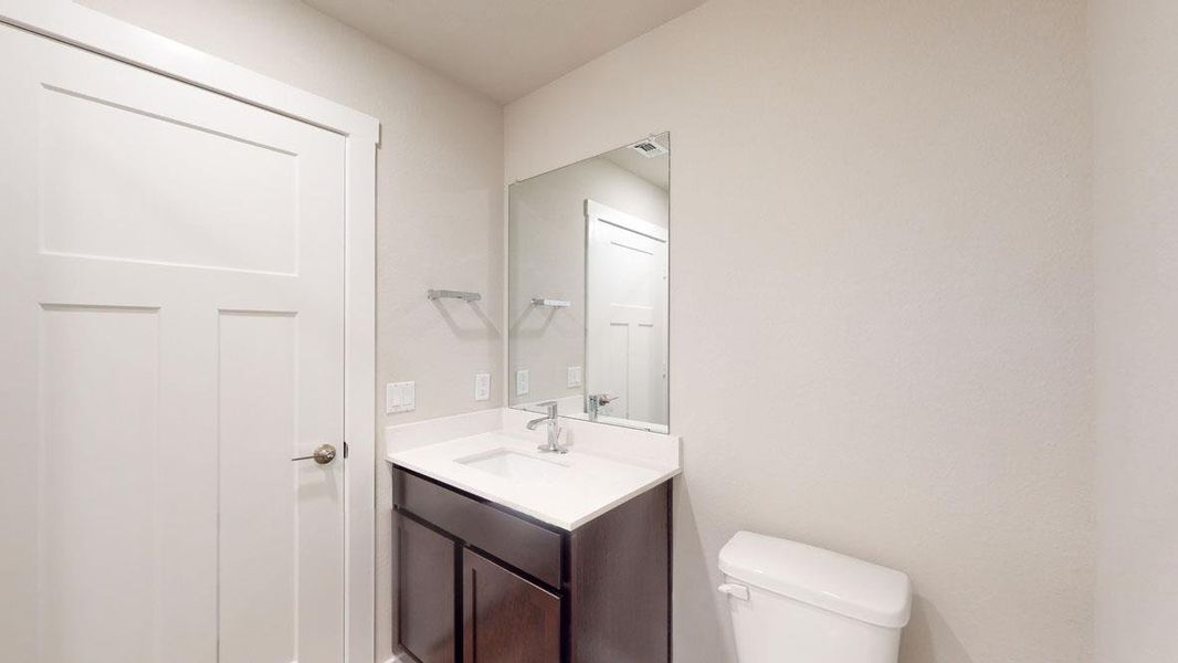 A well-appointed bathroom with a sleek vanity and convenient commode. A well-appointed bathroom with a sleek vanity and convenient commode.