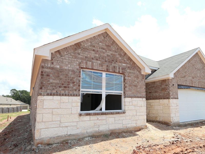 Front exterior of a new home in Magnolia Ridge, Magnolia, TX, highlighting curb appeal (Image 15). Front exterior of a new home in Magnolia Ridge, Magnolia, TX, highlighting curb appeal (Image 15).