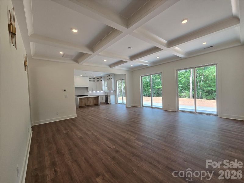 Great room open to the kitchen. Filled with light from the three 8ft doors overlooking the private backyard. Great room open to the kitchen. Filled with light from the three 8ft doors overlooking the private backyard.