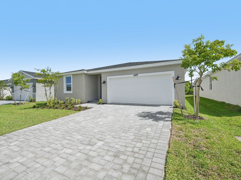 Front exterior of a new home in Hampton Park - Classic Series, Vero Beach, FL, highlighting curb appeal (Image 2). Front exterior of a new home in Hampton Park - Classic Series, Vero Beach, FL, highlighting curb appeal (Image 2).