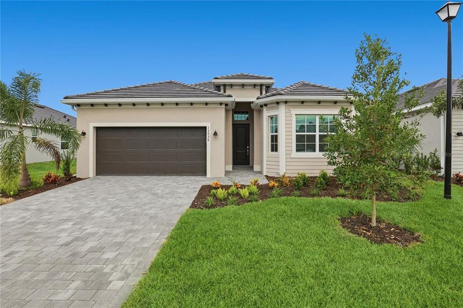 Front exterior of a new home in Wellen Park Golf & Country Club, Venice, FL, highlighting curb appeal (Image 1). Front exterior of a new home in Wellen Park Golf & Country Club, Venice, FL, highlighting curb appeal (Image 1).