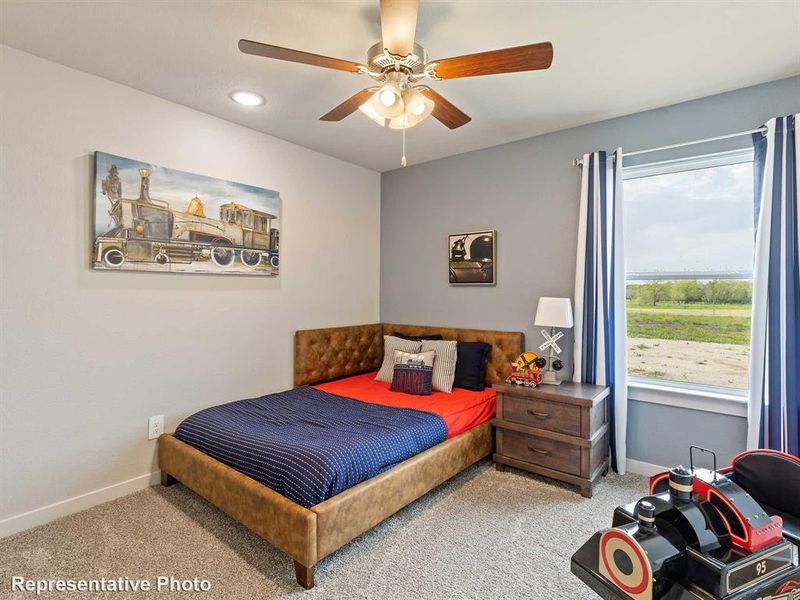 Well-lit bedroom with a ceiling fan, recessed lighting, a large window, and carpet flooring