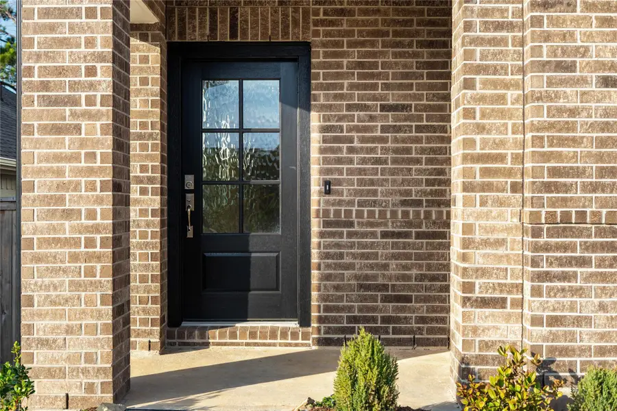 This home is modern elegance with a timeless brick exterior and high quality entry door.