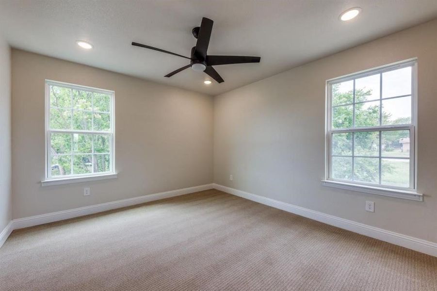 Empty room with a healthy amount of sunlight and carpet floors