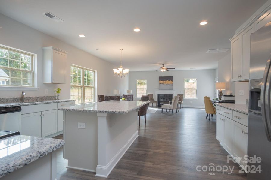 Kitchen into Family Room. Photo representation. Colors and options will differ.