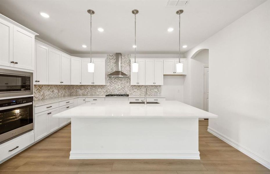 Oversized island in the kitchen with ample cabinet space  *real home pictured