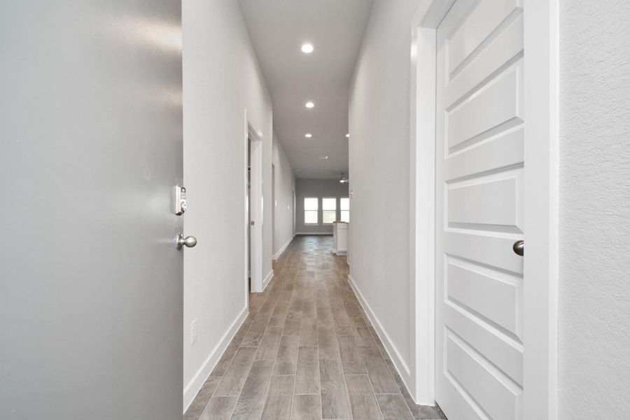 Indulge in luxury as you step into the threshold of this breathtaking home. The grand entrance beckons with its soaring ceilings, adorned with elegant wood-look tile flooring featuring sleek oversized baseboards. Sample photo of completed home with similar floor plan. As-built interior colors and selections may vary. Indulge in luxury as you step into the threshold of this breathtaking home. The grand entrance beckons with its soaring ceilings, adorned with elegant wood-look tile flooring featuring sleek oversized baseboards. Sample photo of completed home with similar floor plan. As-built interior colors and selections may vary.