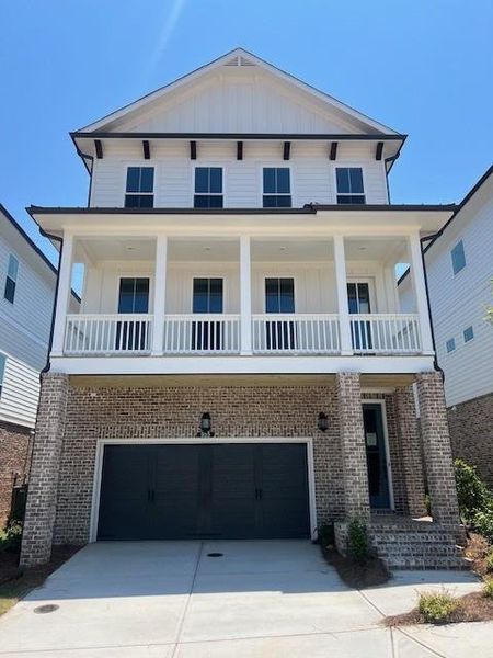 Front exterior of a new home in Palisades Single Family, Cumming, GA, highlighting curb appeal (Image 1).
