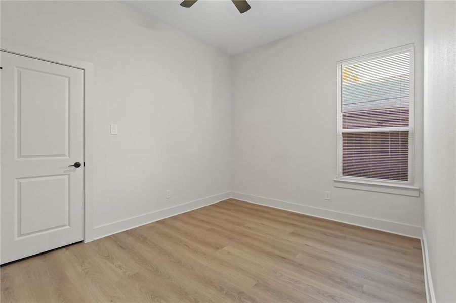 Spare room featuring light wood-type flooring and a ceiling fan