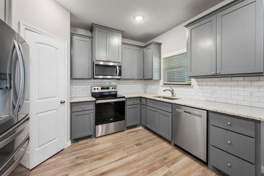 A closer look reveals the gleaming granite, subway tile back splash and large walk in pantry. The view of your picturesque back yard from the window is amazing!