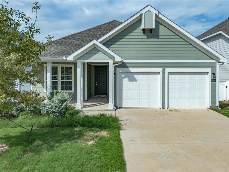 View of front facade with concrete driveway, roof with shingles, a front lawn, and a garage View of front facade with concrete driveway, roof with shingles, a front lawn, and a garage