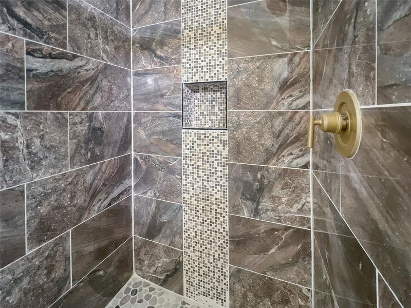 Interior details featuring a tile shower