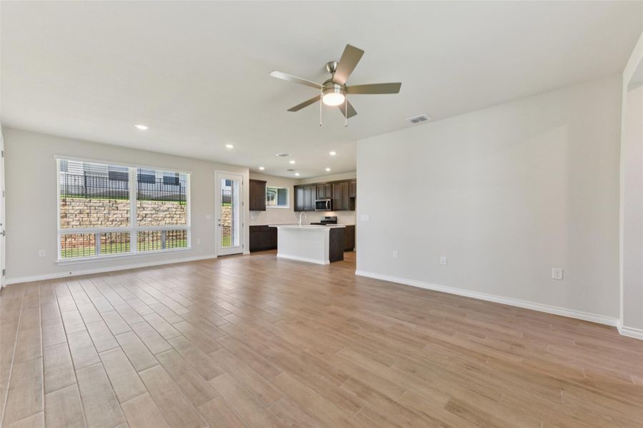 Unfurnished living room featuring recessed lighting, light wood-type flooring, and ceiling fan Unfurnished living room featuring recessed lighting, light wood-type flooring, and ceiling fan