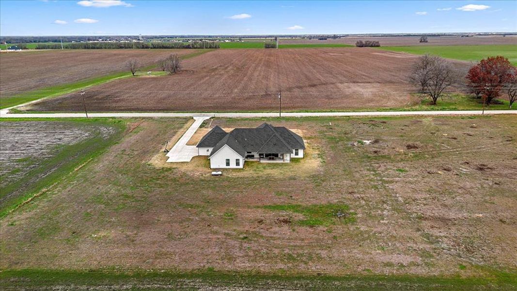 Birds eye view of property with a rural view