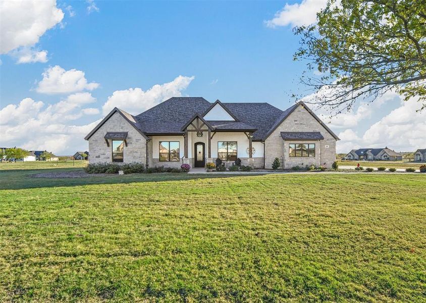 French country style house with a front yard