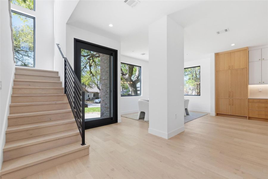 Entryway with light wood-style floors and recessed lighting