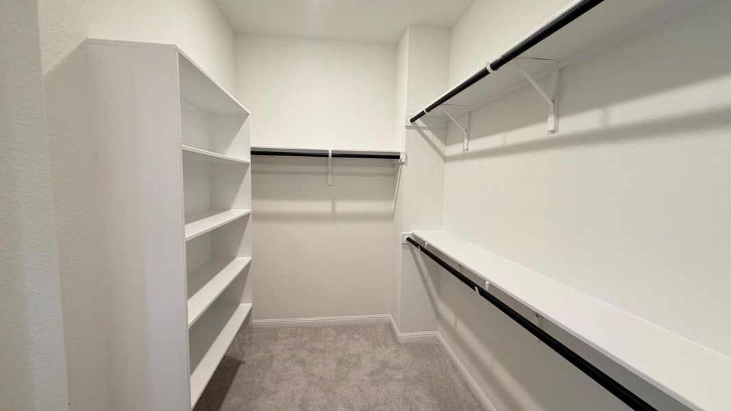 Custom shelving and hanging rods define this spacious, well-organized closet. Custom shelving and hanging rods define this spacious, well-organized closet.