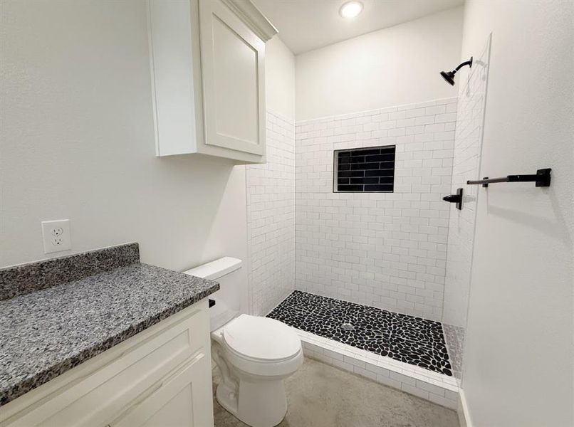 Bathroom featuring a shower stall and vanity Bathroom featuring a shower stall and vanity