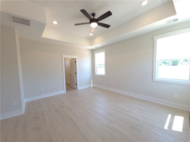 This spacious bedroom offers ample natural light a